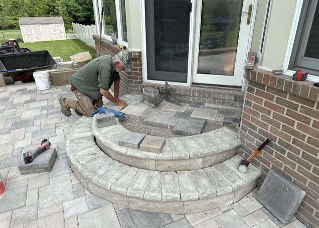 Rock Guys crew completing a brick paver patio installation in Southeast Michigan